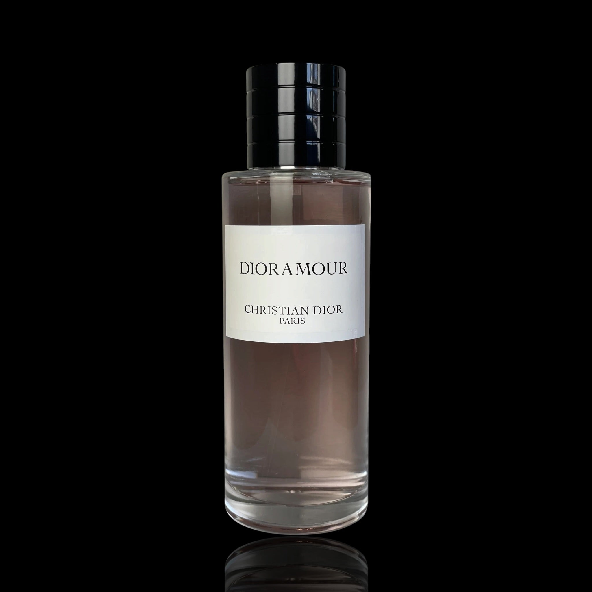 Christian Dior Dioramour Eau de Parfum in a clear glass bottle with a white label and a black cap, set against a solid black background.