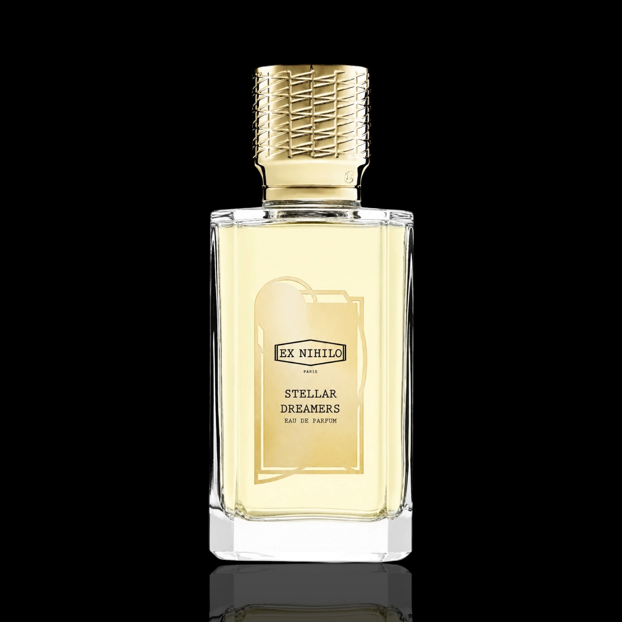 A bottle of Ex nihilo Stellar Dreamers Eau de Parfum with pale yellow liquid, a textured gold cap, and a gold label, set against a solid black background with a subtle reflection below.