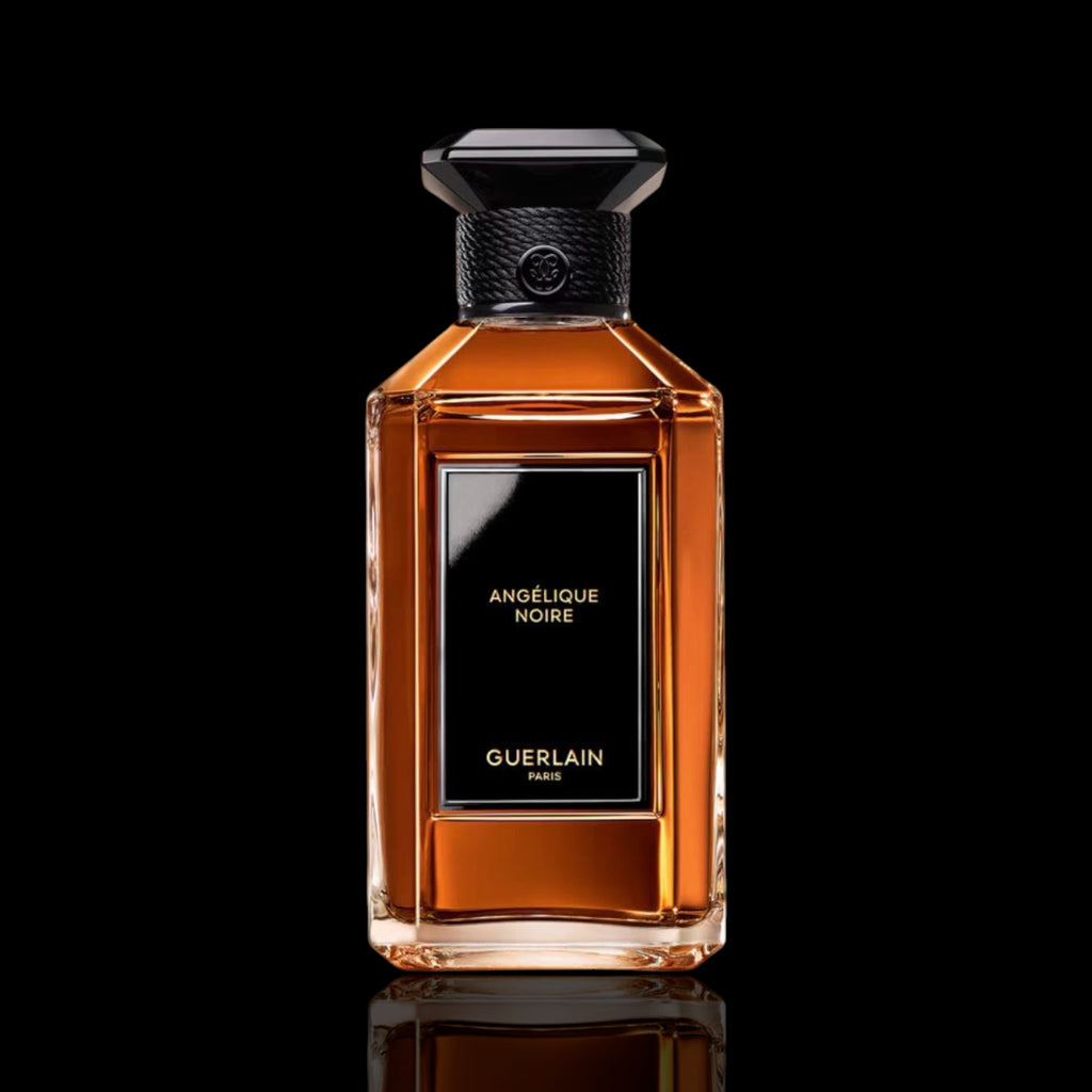 Guerlain Angelique noire perfume bottle with black cap on a reflective surface