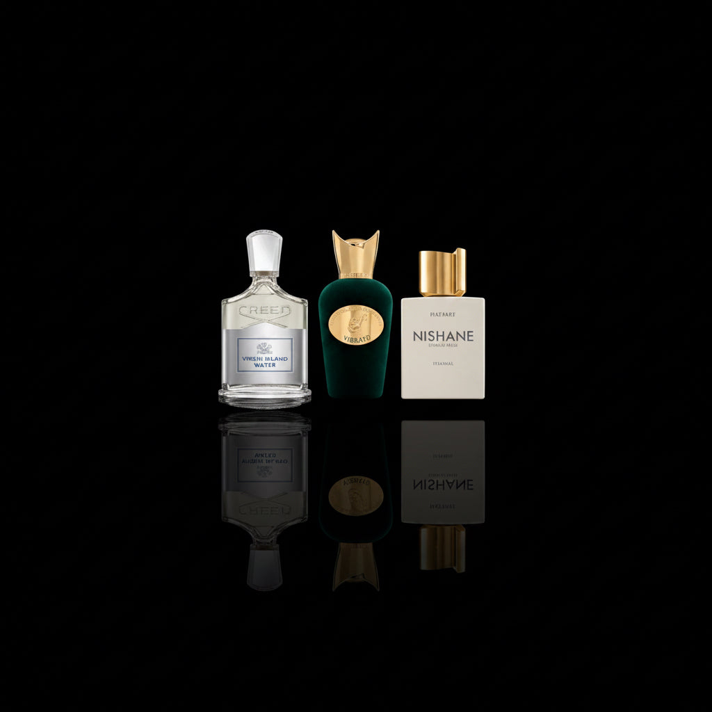 Three perfume bottles arranged side by side on a glossy black reflective surface against a black background. The left bottle is Crees Virgin Island Water clear glass with pale gold liquid and a white cap; the middle bottle is Sospiro Vibrato dark green glass with a gold cap and gold oval emblem; the right bottle is Nishbne hacivat white with a gold cap and the brand name NISHANE visible on the front.