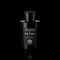 Acqua di Parma Zafferano bottle with black glass and gold lettering on a black reflective background.