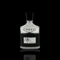 Creed Aventus bottle with clear glass and black label on a black background