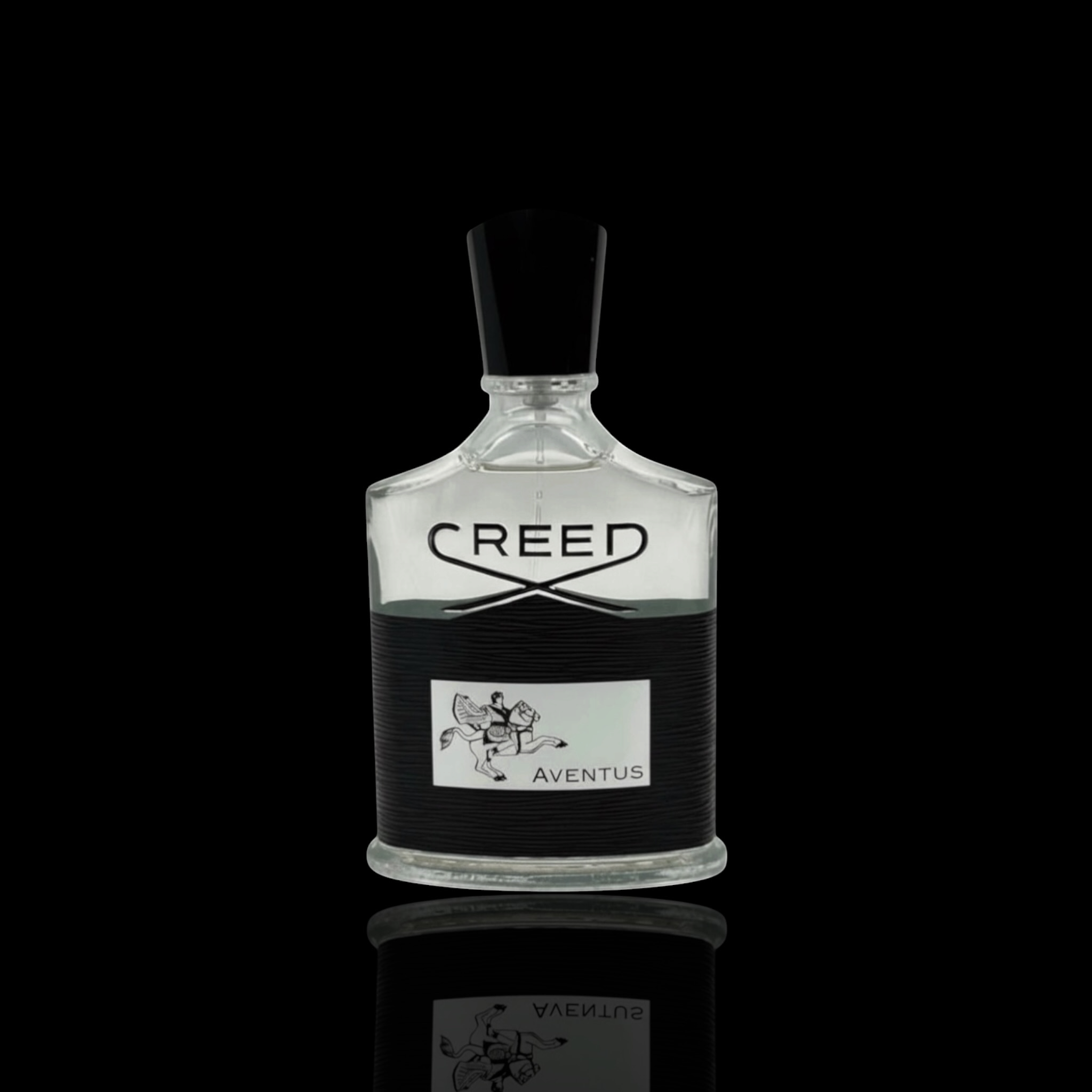 Creed Aventus bottle with clear glass and black label on a black background