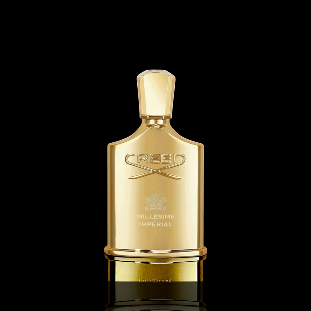 Creed Millesime Imperial bottle with gold finish on a black background