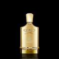 Creed Millesime Imperial bottle with gold finish on a black background