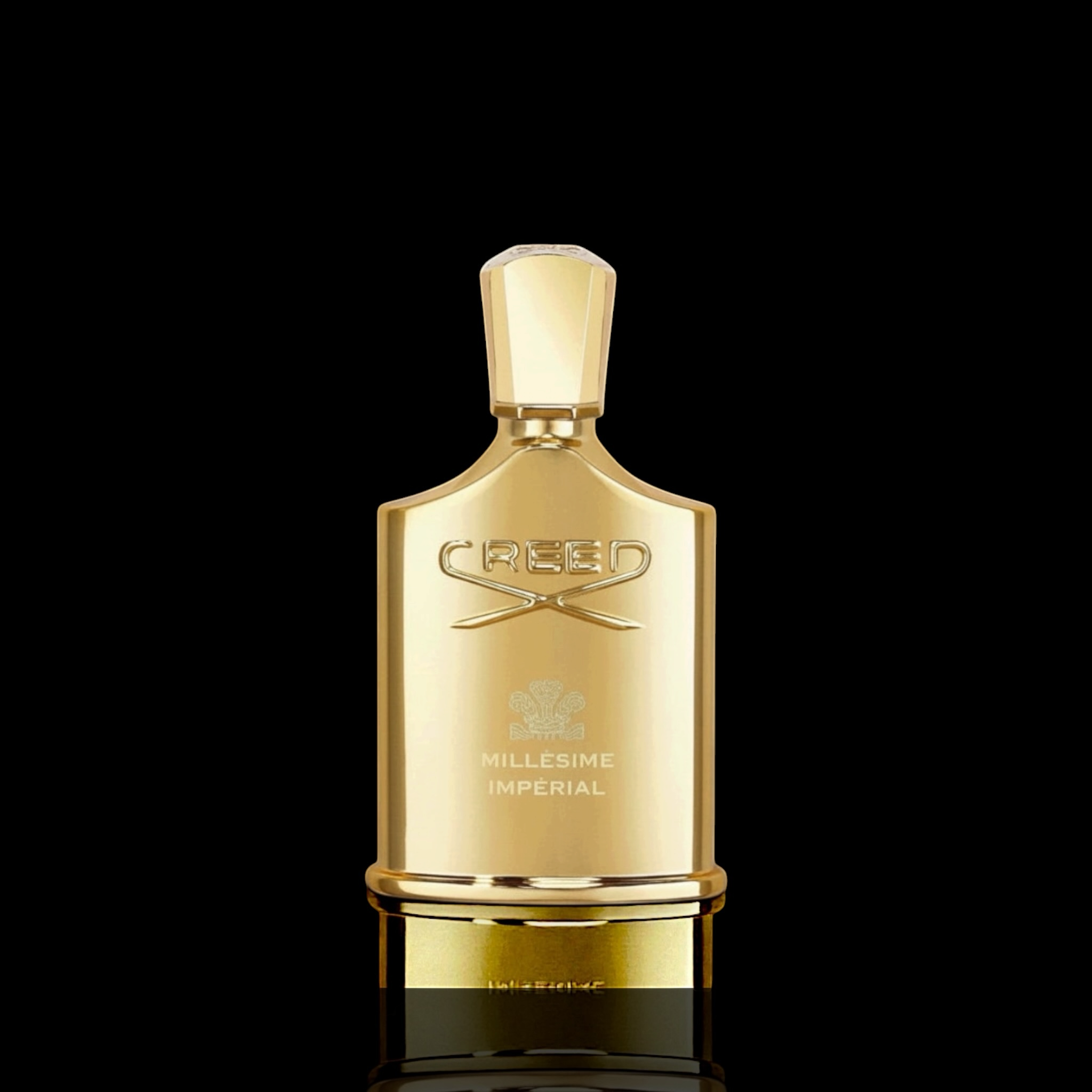 Creed Millesime Imperial bottle with gold finish on a black background