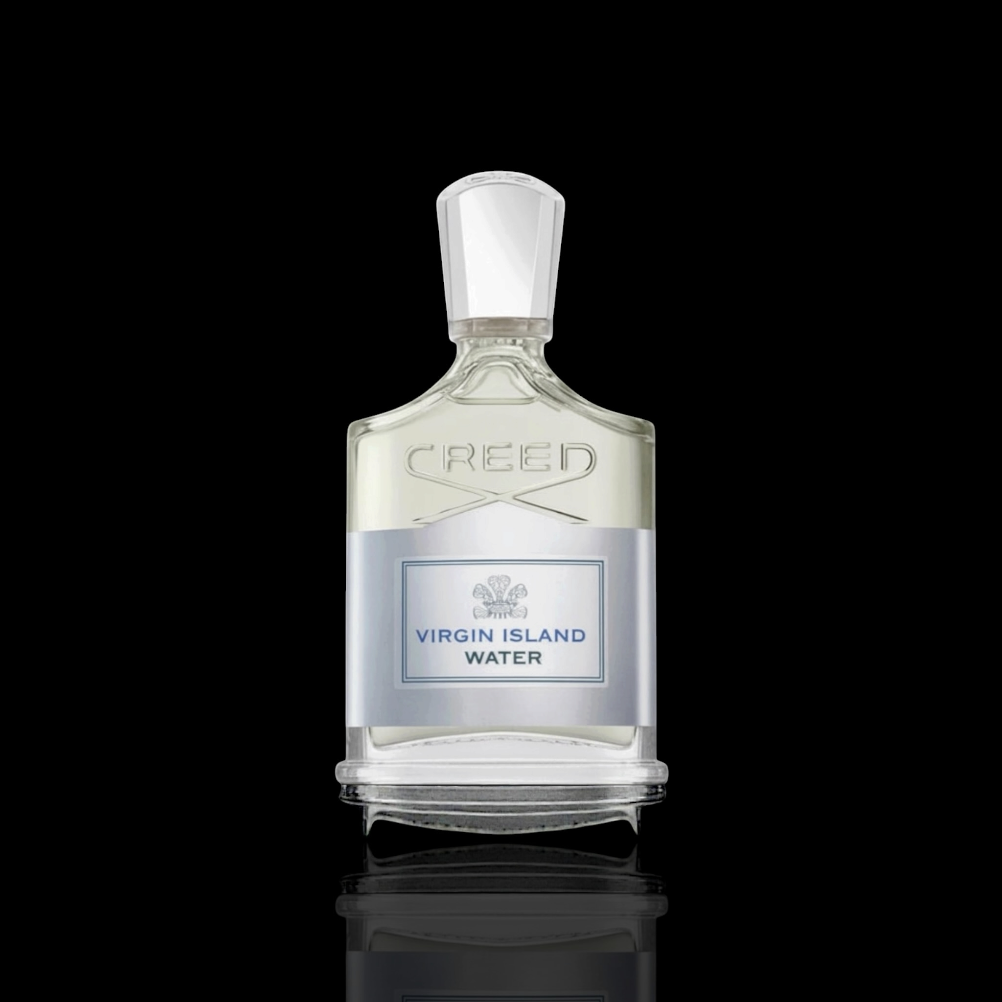 Creed Virgin Island Water bottle with clear glass and silver accents on a black reflective background.
