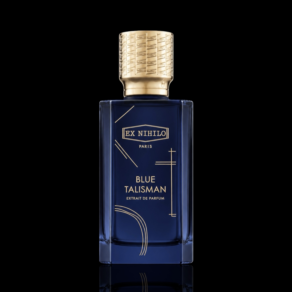 Ex Nihilo Blue Talisman Extrait de Parfum bottle with deep blue glass and gold accents on a black reflective background.