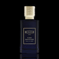 Ex Nihilo Fleur Narcotique Extrait de Parfum bottle with deep blue glass and gold accents on a black reflective background.