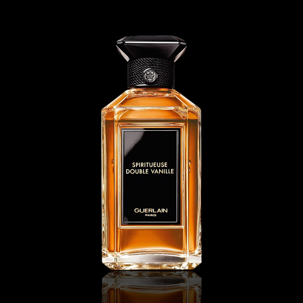 Guerlain Spiritueuse Double Vanille bottle with amber glass and ornate label on a black background