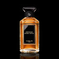 Guerlain Spiritueuse Double Vanille bottle with amber glass and ornate label on a black background