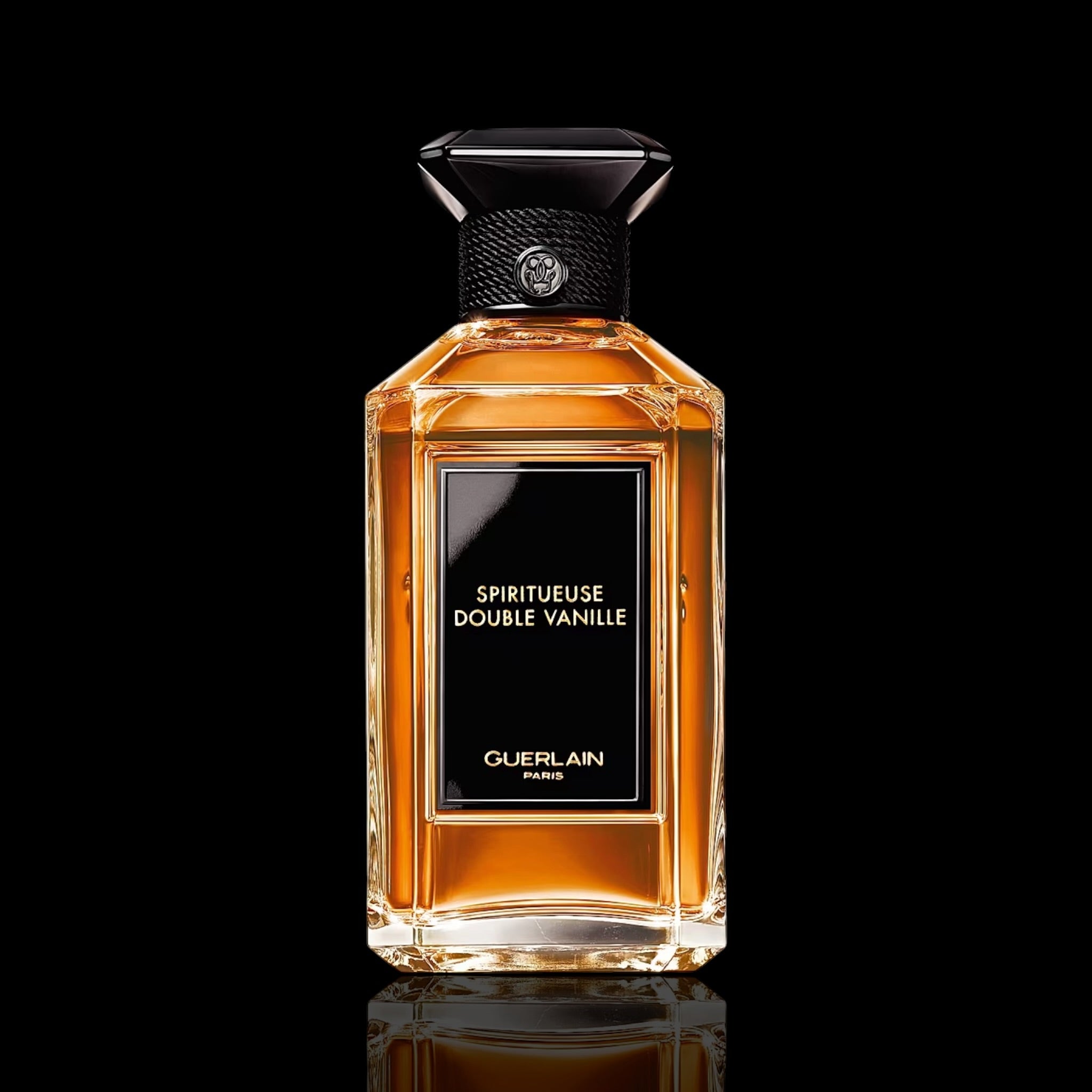 Guerlain Spiritueuse Double Vanille bottle with amber glass and ornate label on a black background