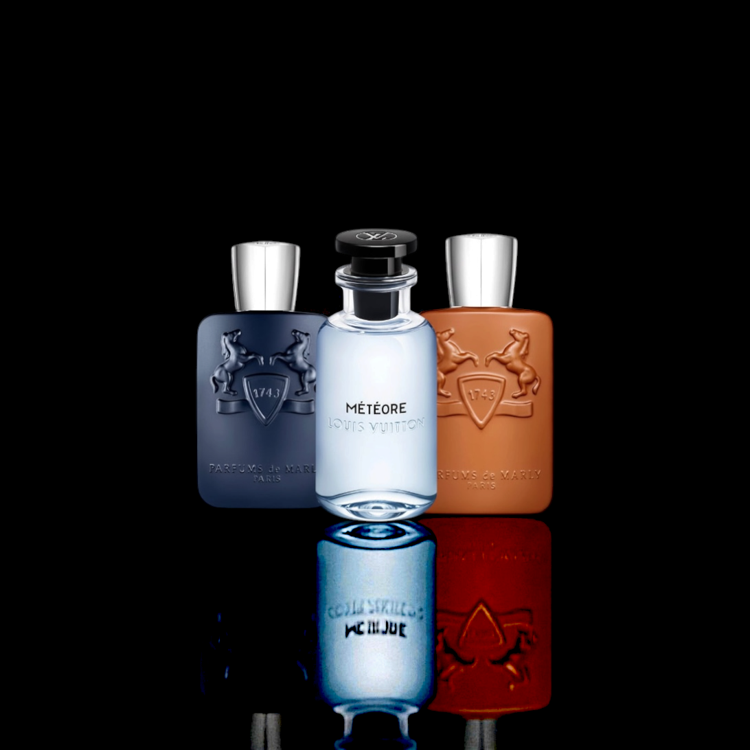 Parfums de Marly Layton, Louis Vuitton Météore, and Parfums de Marly Althair bottles displayed together on a black background with reflective surface