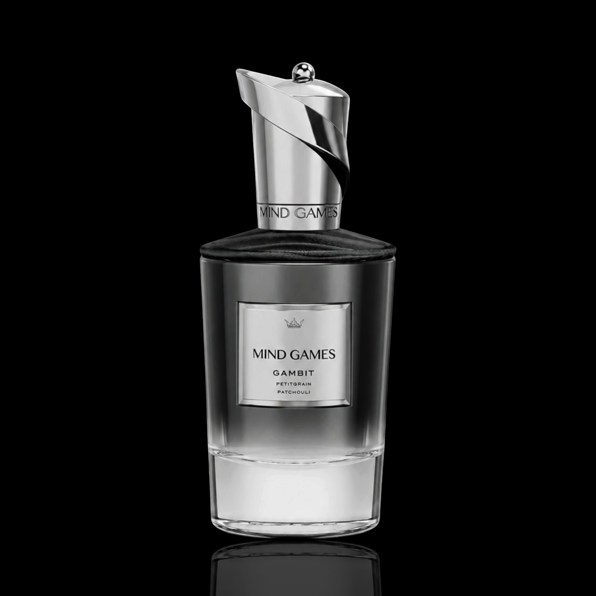 Mind Games Gambit Extrait de Parfum bottle with black and silver gradient design on a black reflective background.