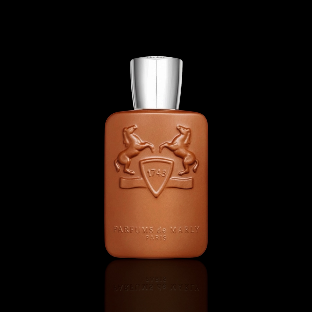 Parfums de Marly Althair bottle with warm amber finish and silver cap on a black reflective background.