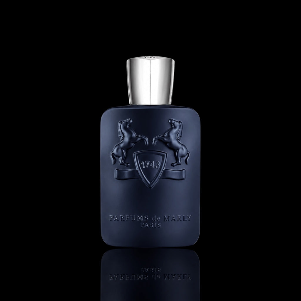 Parfums de Marly Layton bottle with deep navy blue finish and silver cap on a black reflective background.