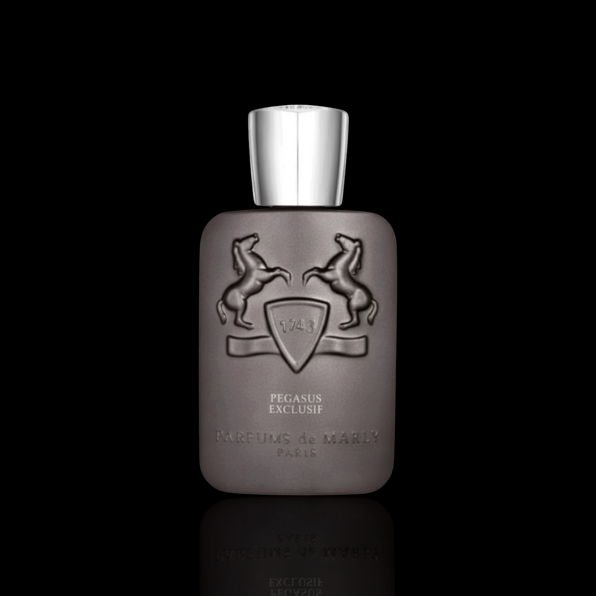 Parfums de Marly Pegasus Exclusif bottle with metallic taupe finish and silver cap on a black reflective background.