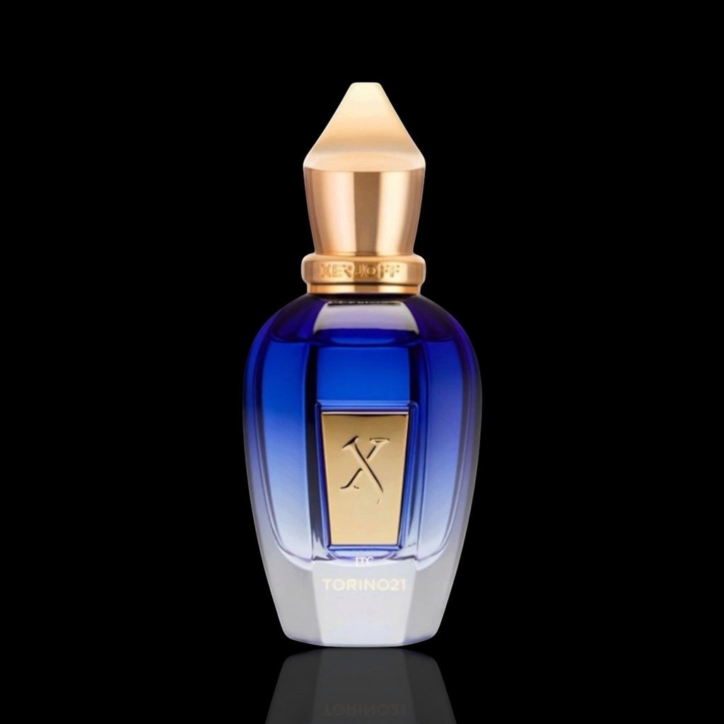 Xerjoff Torino 21 bottle with blue gradient glass and gold accents on a black reflective background.