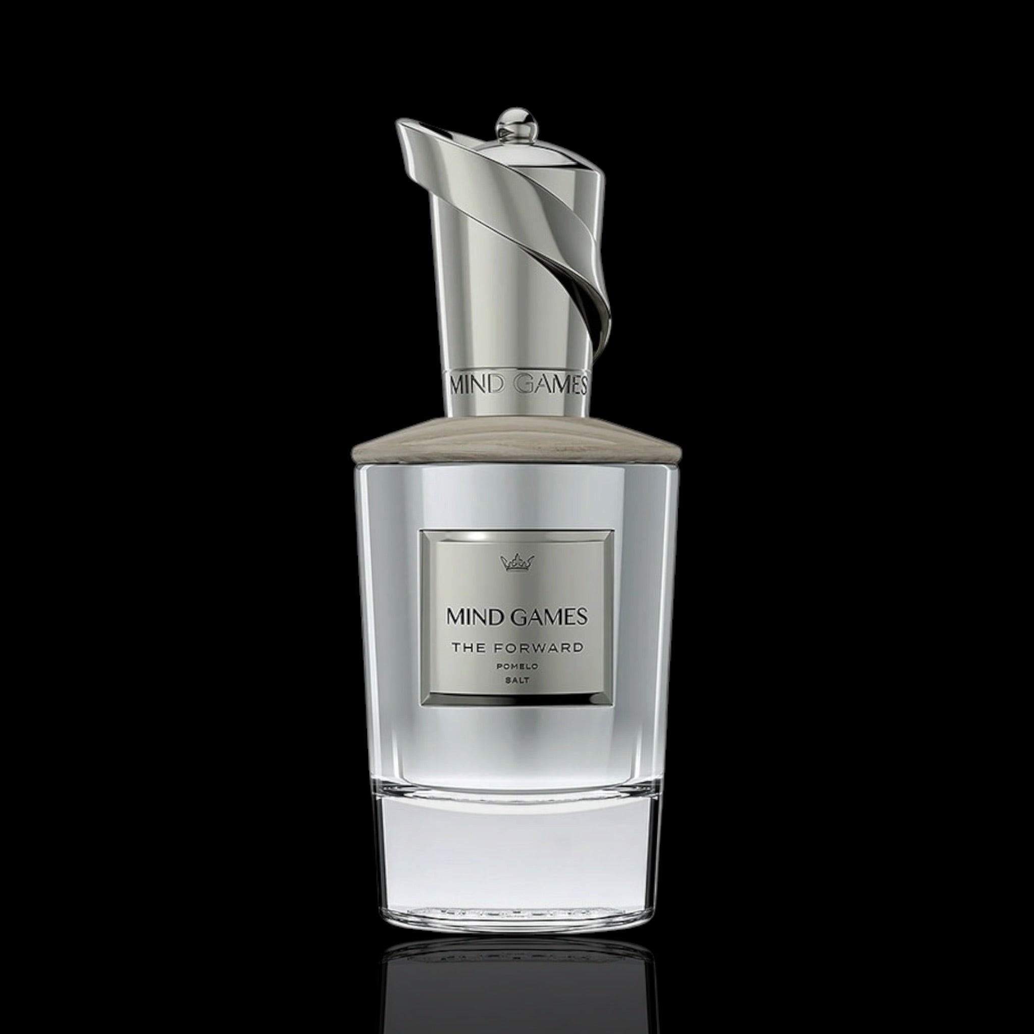 A clear glass perfume bottle with a metallic silver cap and a silver label reading 'MIND GAMES THE FORWARD PARFUMS DE MARLY', centered on a black background.