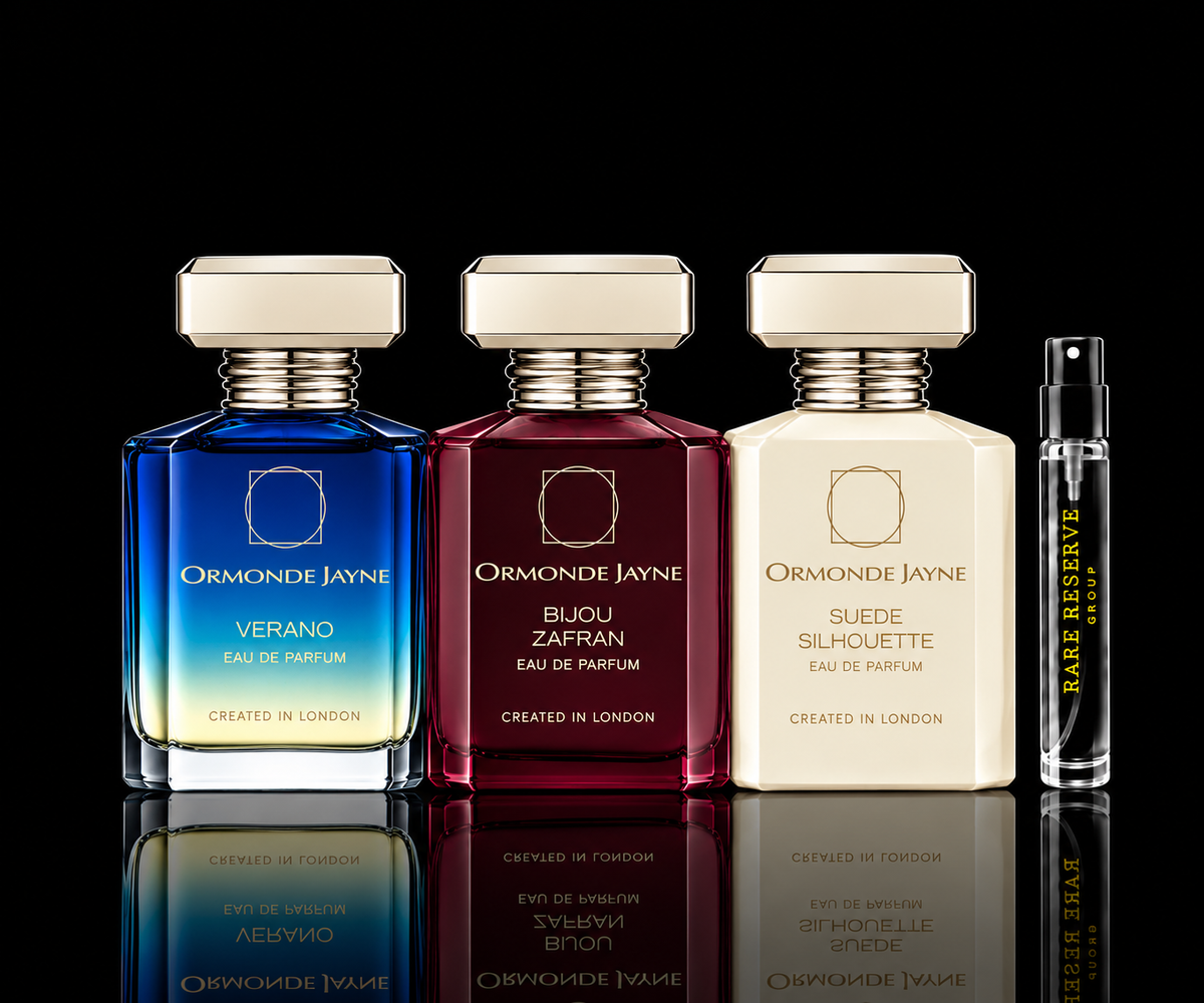 Ormonde Jayne Signature Collection featuring Verano, Bijou Zafran, and Suede Silhouette fragrance bottles beside a Rare Reserve Group decant atomizer on a black reflective background