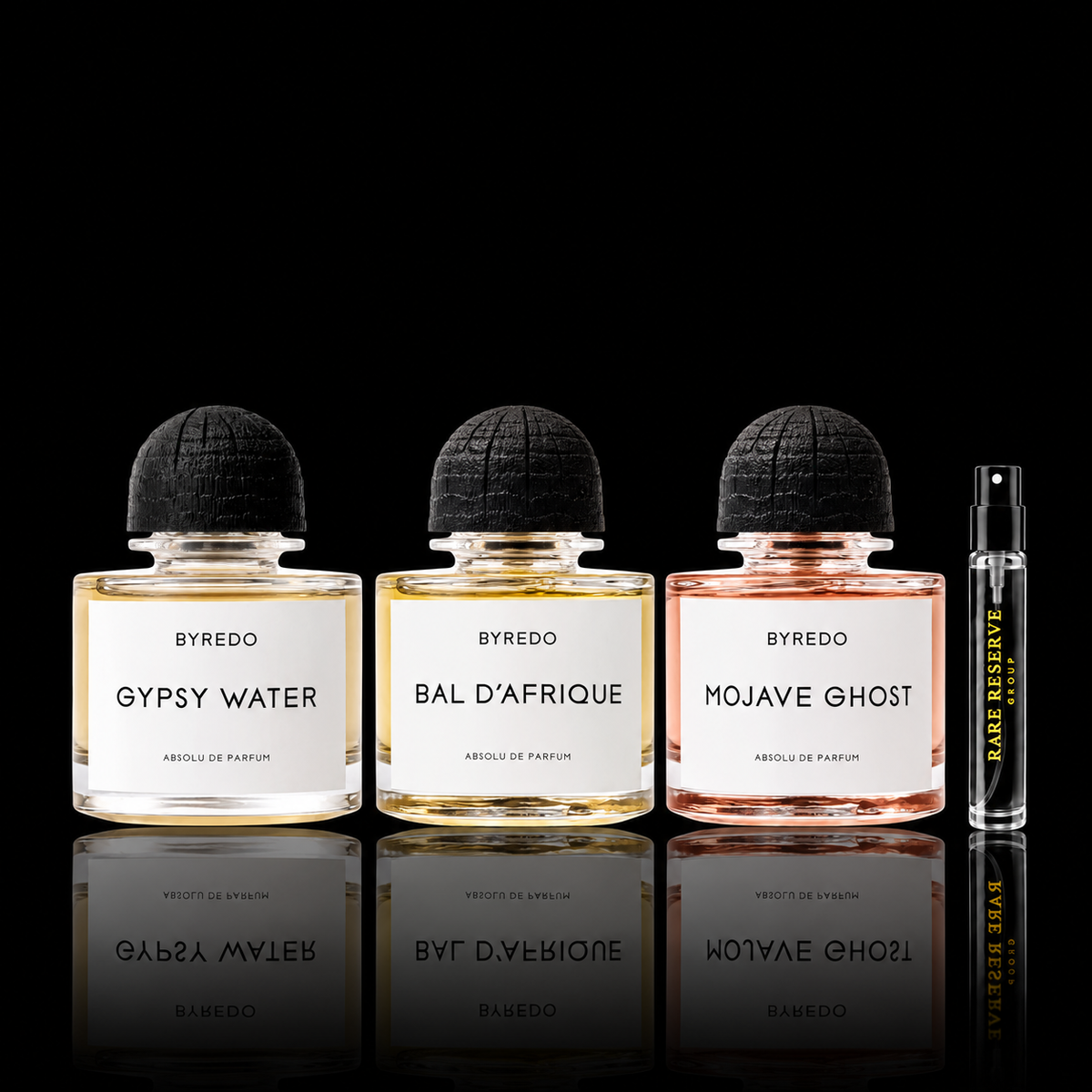 Byredo Absolu Collection featuring Bal d’Afrique Absolu, Mojave Ghost Absolu and Gypsy Water Absolu source bottles beside a Rare Reserve Group decant atomizer. Full retail bottles not included.