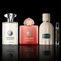 Amouage Reserve Collection featuring Reflection Man, Guidance 46 and Outlands bottles with a Rare Reserve Group decant atomizer on a black reflective background